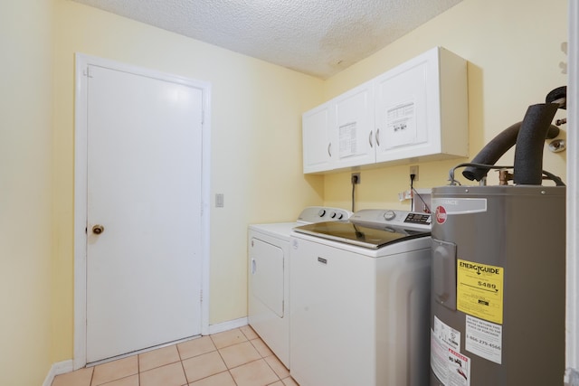 clothes washing area with cabinet space, light tile patterned floors, electric water heater, a textured ceiling, and washer and dryer