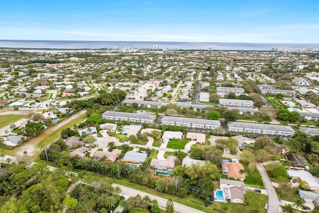 drone / aerial view featuring a water view and a residential view