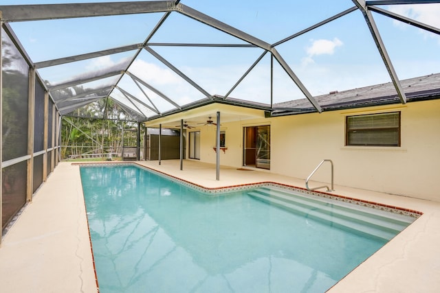 outdoor pool with a lanai, ceiling fan, and a patio