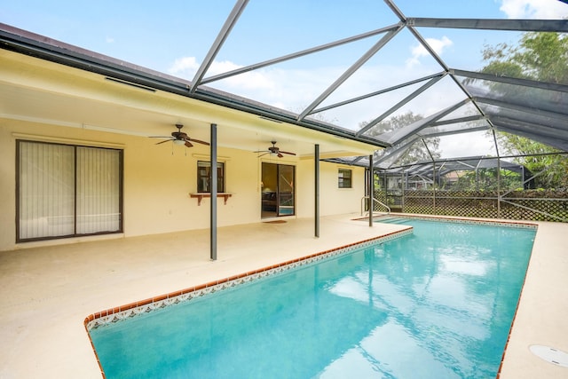 pool with ceiling fan, glass enclosure, and a patio area