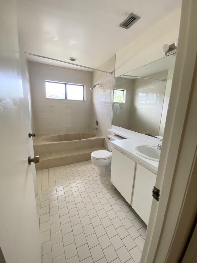 full bathroom with visible vents, toilet, tub / shower combination, vanity, and tile patterned flooring