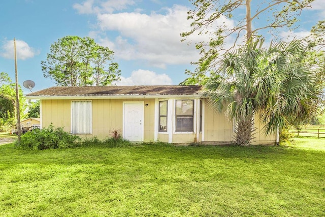 rear view of property with a lawn