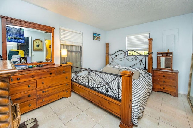 bedroom featuring a textured ceiling and light tile patterned flooring