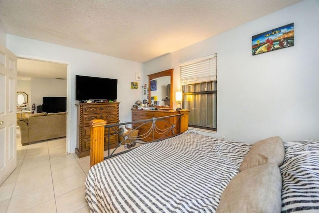 bedroom with a textured ceiling and light tile patterned flooring