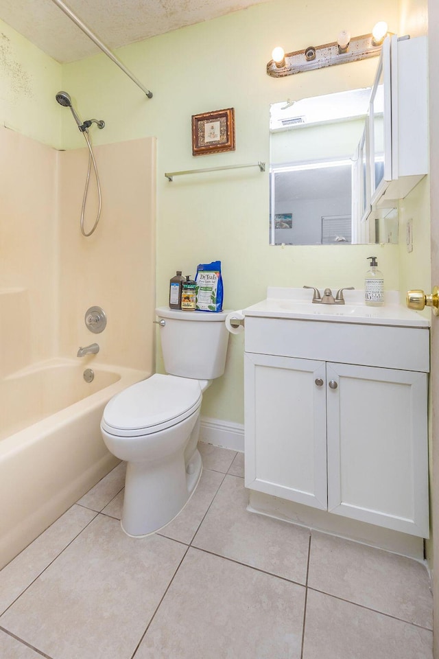 bathroom featuring baseboards, toilet, shower / bathtub combination, tile patterned flooring, and vanity