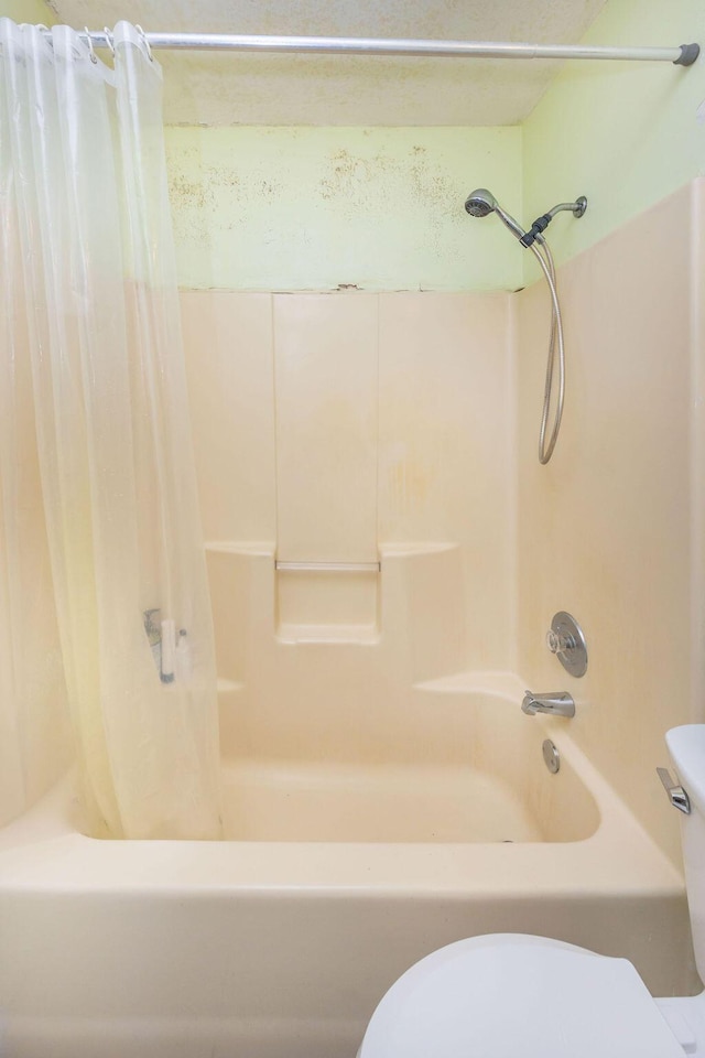 full bath featuring shower / tub combo and toilet