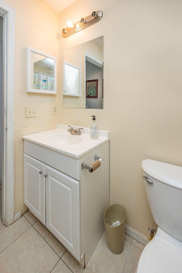 bathroom featuring toilet, tile patterned flooring, and vanity