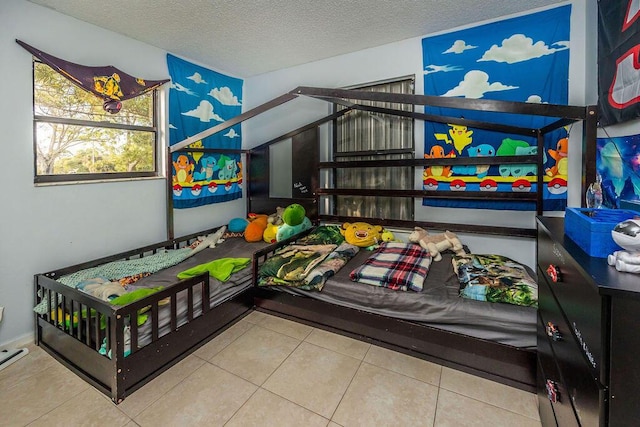 tiled bedroom with a textured ceiling