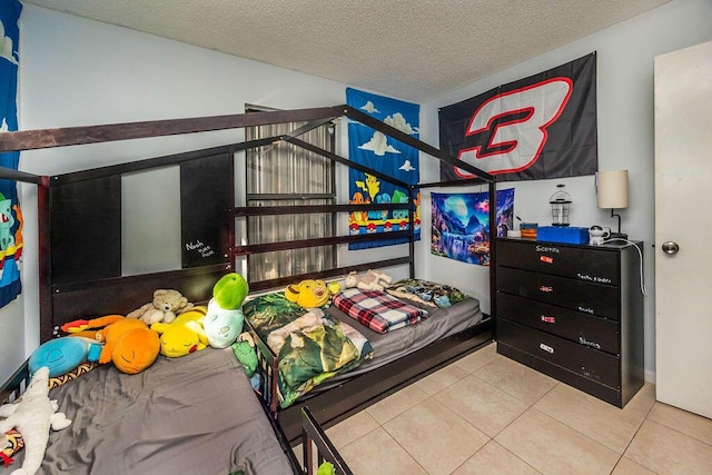 bedroom with tile patterned flooring and a textured ceiling