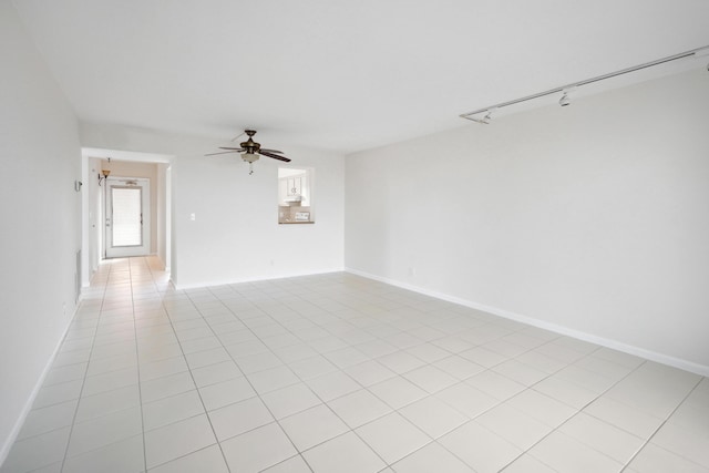 unfurnished room with light tile patterned floors, baseboards, a ceiling fan, and rail lighting