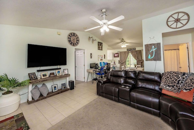 living area featuring a ceiling fan, vaulted ceiling, and tile patterned floors