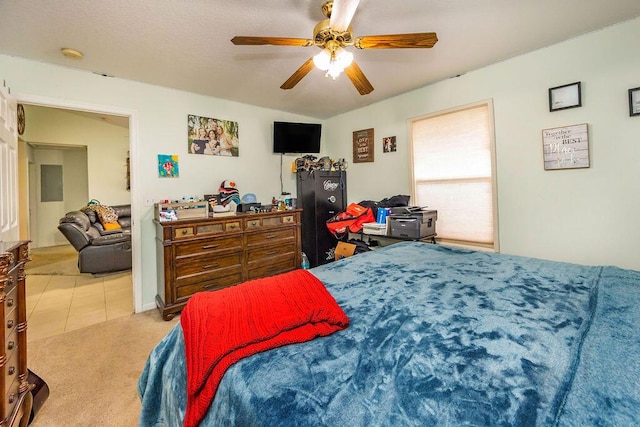 tiled bedroom with a ceiling fan and carpet