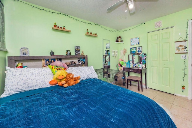 tiled bedroom with a ceiling fan and a textured ceiling