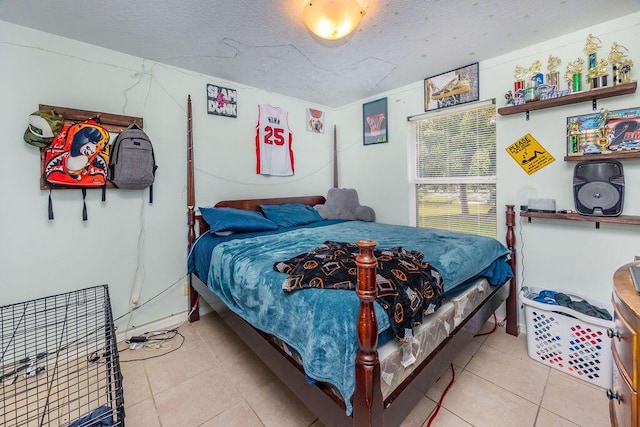 tiled bedroom featuring a textured ceiling