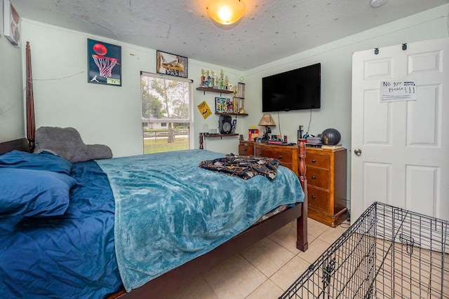 bedroom with light tile patterned floors and a textured ceiling