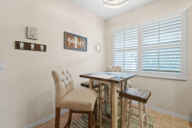 dining space with light tile patterned floors and baseboards