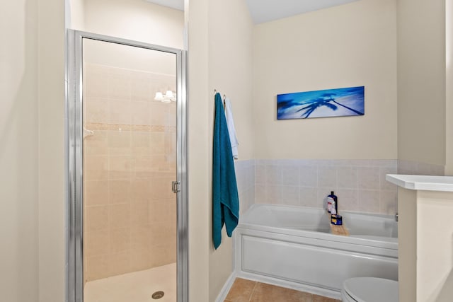 bathroom with tile patterned floors, a shower stall, toilet, and a bath