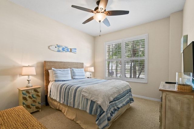 bedroom with a ceiling fan, light colored carpet, and baseboards