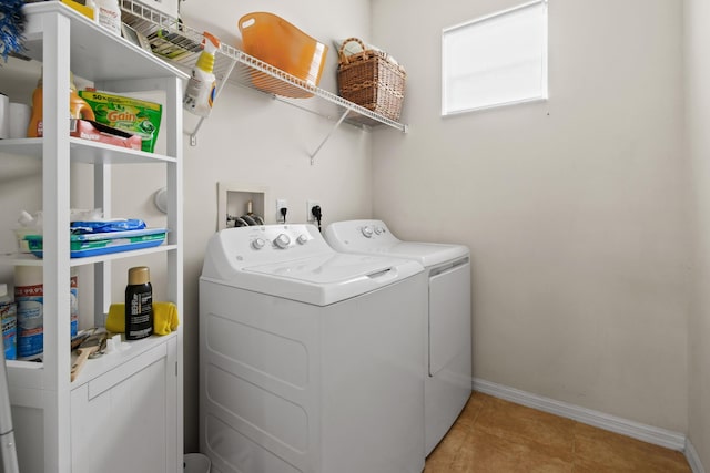 laundry room with laundry area, washing machine and dryer, baseboards, and light tile patterned flooring