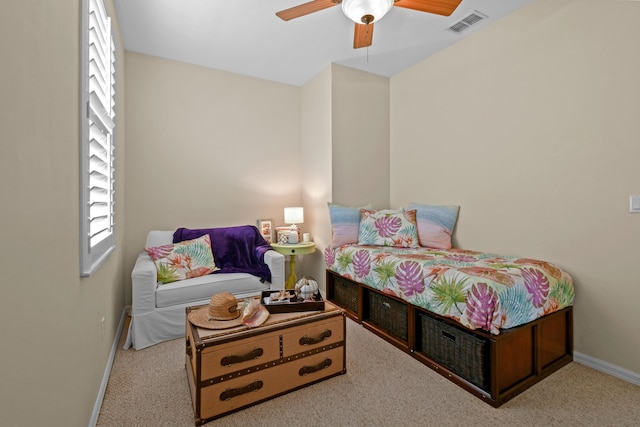 bedroom featuring a ceiling fan, light colored carpet, visible vents, and baseboards