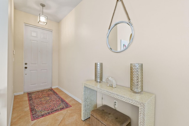 tiled entrance foyer featuring baseboards