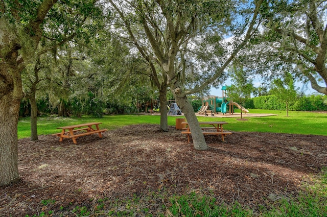 community jungle gym featuring a yard