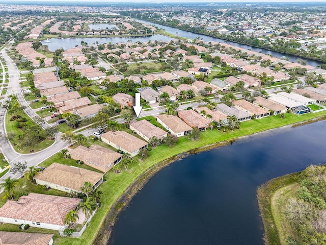 birds eye view of property with a water view and a residential view