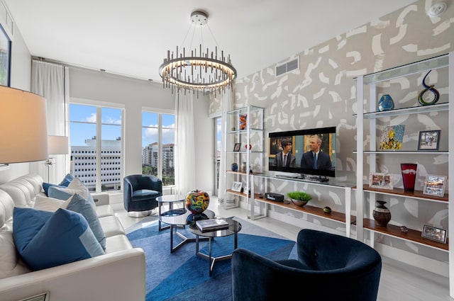 living area with a chandelier, visible vents, and wallpapered walls