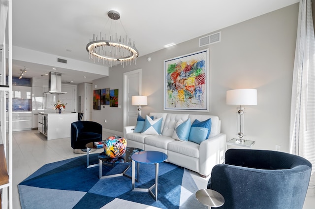 living room featuring an inviting chandelier and visible vents