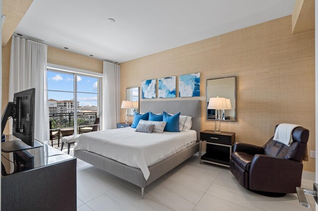 bedroom with wallpapered walls, access to outside, and light tile patterned floors