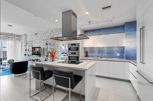 kitchen with a kitchen island, light countertops, island exhaust hood, and modern cabinets