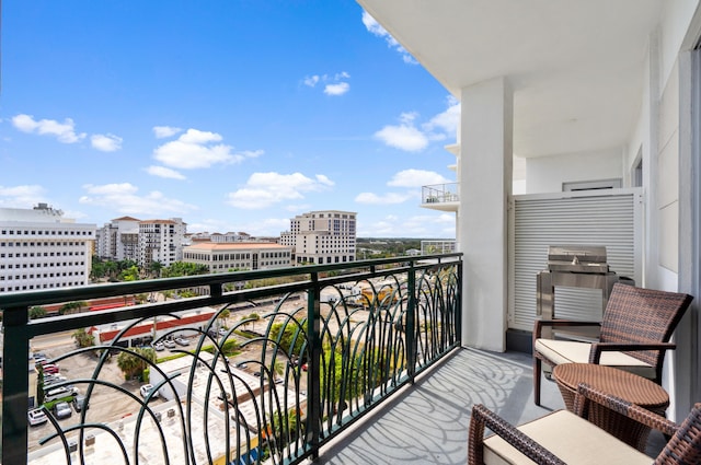 balcony with a view of city and grilling area