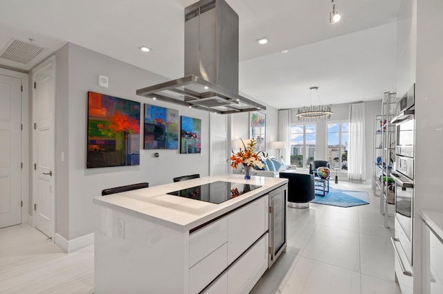 kitchen with white cabinets, modern cabinets, a kitchen island, island exhaust hood, and light countertops