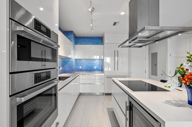 kitchen featuring white cabinetry, light countertops, appliances with stainless steel finishes, modern cabinets, and island exhaust hood