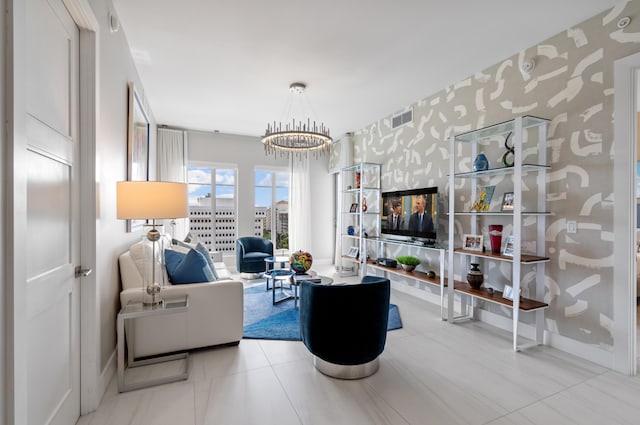 living room featuring baseboards, an inviting chandelier, visible vents, and wallpapered walls