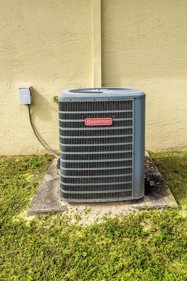 details featuring central air condition unit and stucco siding