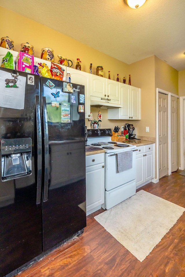 kitchen featuring white electric range oven, black refrigerator with ice dispenser, dark wood-type flooring, white cabinetry, and under cabinet range hood