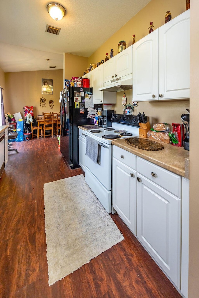 kitchen with white electric range oven, decorative light fixtures, freestanding refrigerator, under cabinet range hood, and white cabinetry