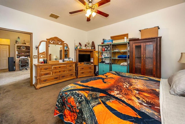 bedroom featuring visible vents, dark carpet, and ceiling fan