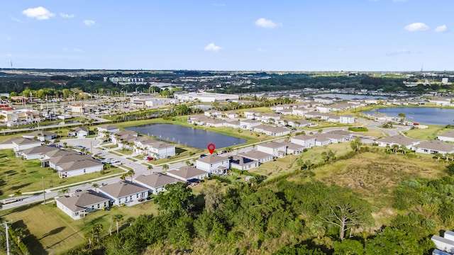 birds eye view of property with a water view and a residential view