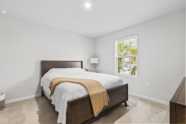 bedroom featuring carpet and baseboards