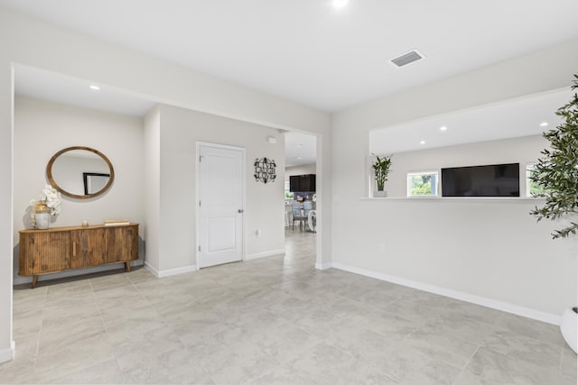 unfurnished room with recessed lighting, visible vents, and baseboards