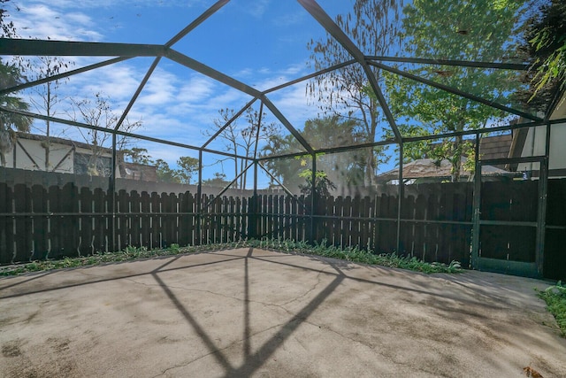 view of patio / terrace with a lanai and fence