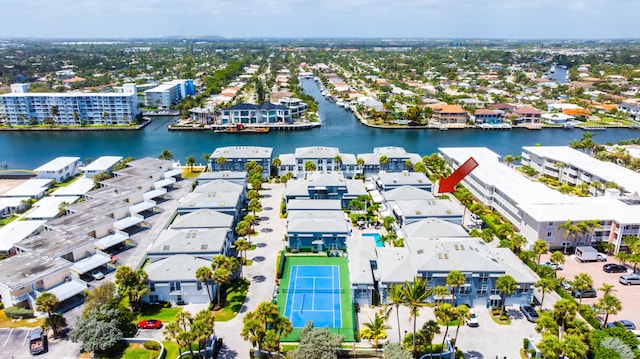 drone / aerial view featuring a residential view and a water view