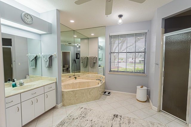 bathroom featuring a garden tub, a shower stall, a ceiling fan, and tile patterned floors