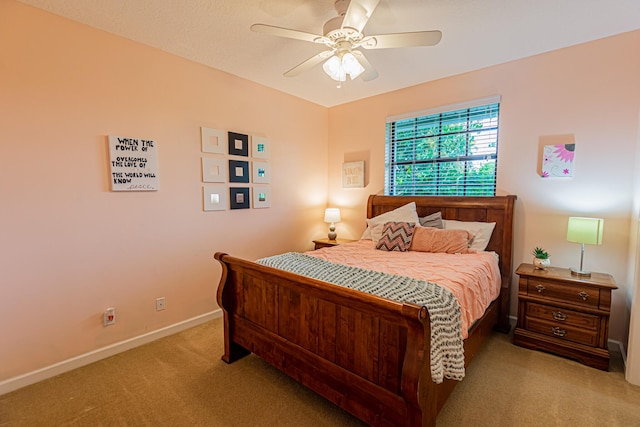 bedroom featuring light carpet, ceiling fan, and baseboards