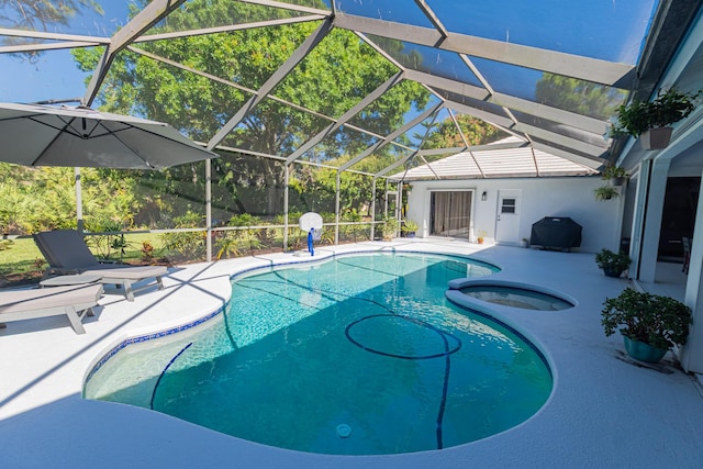 outdoor pool with glass enclosure, a patio area, and an in ground hot tub