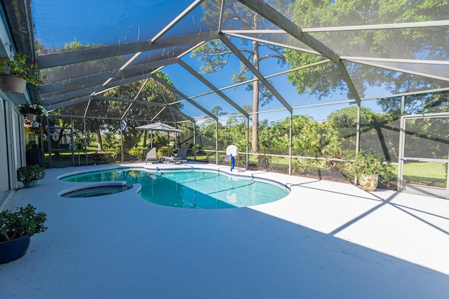 outdoor pool featuring a patio area and glass enclosure