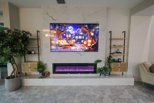 home theater with a glass covered fireplace