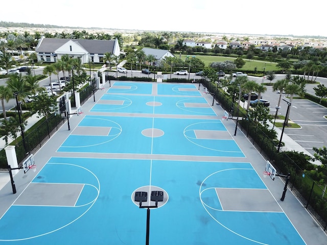 view of basketball court featuring community basketball court, a residential view, and fence